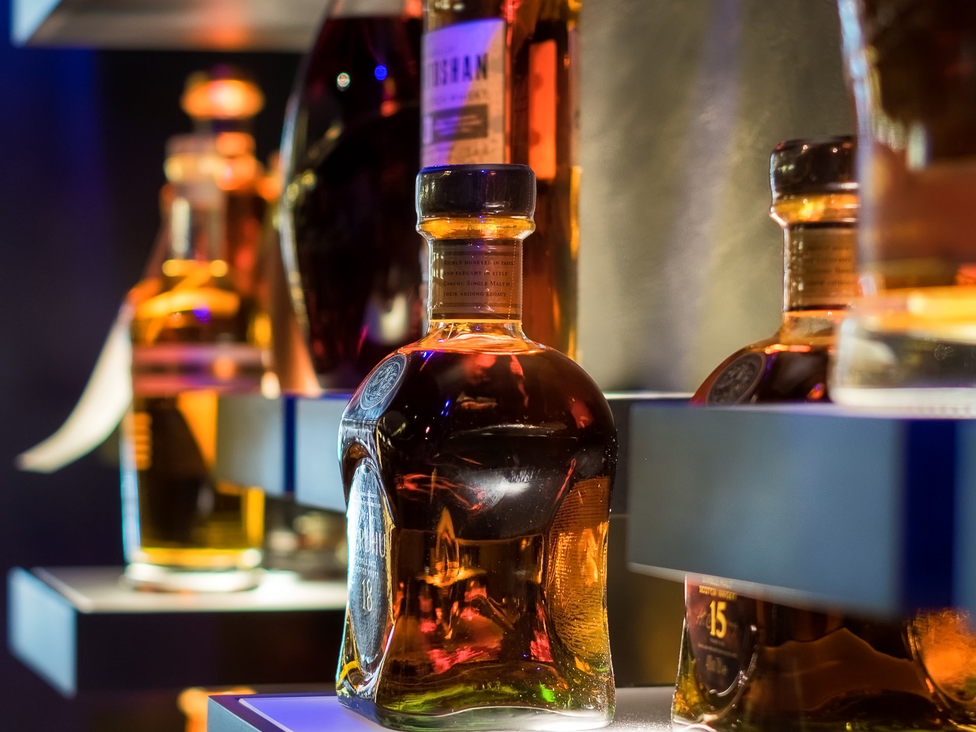 Finest wines and more: wine holiday in Austria at Cervosa Various whiskey bottles on illuminated shelves in a bar