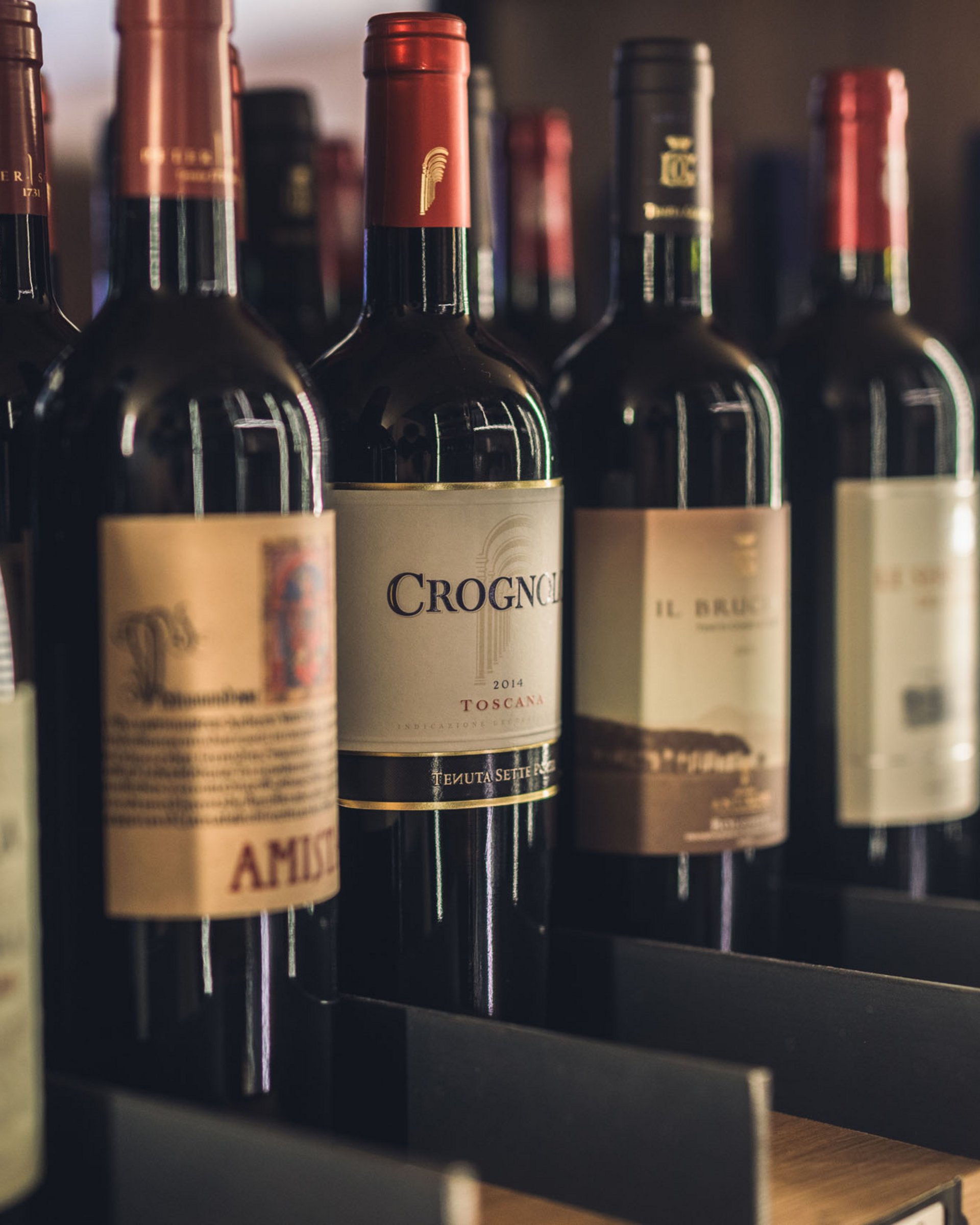 Finest wines and more: wine holiday in Austria at Cervosa Several bottles of red wine in a wooden wine rack